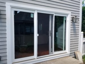 White frames sliding glass patio doors installed in a house.