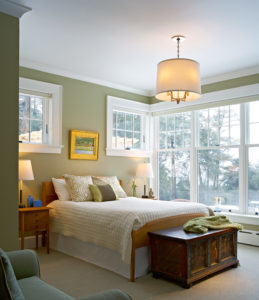 Bedroom with a bed, nightstand, hanging light fixture, and a single-hung windows
